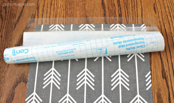 Adhere contact paper to wrapping paper