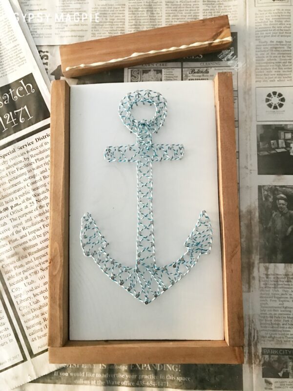 Add a small bit of glue then brad nail on the frame for your DIY string art | Gypsy Magpie