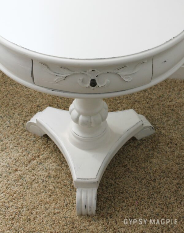 White pedestal table with papered drawers. Darling!