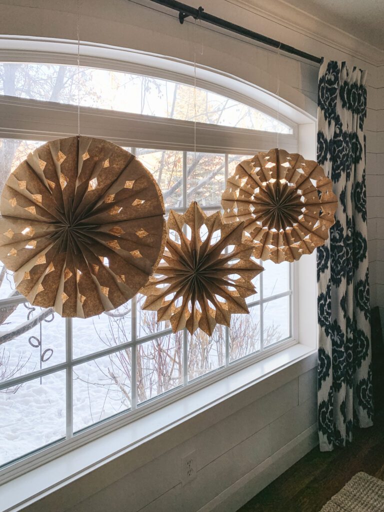 A picture window of paper bag snowflakes | gypsy magpie