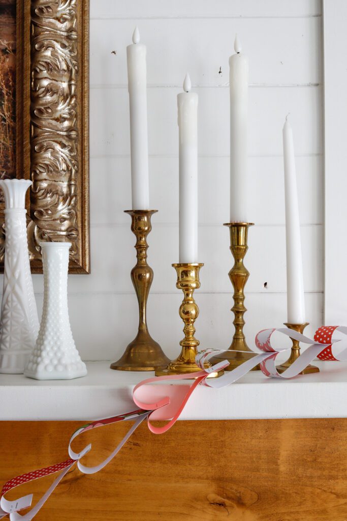 vintage candlesticks and milk glass with paper hearts for Valentines